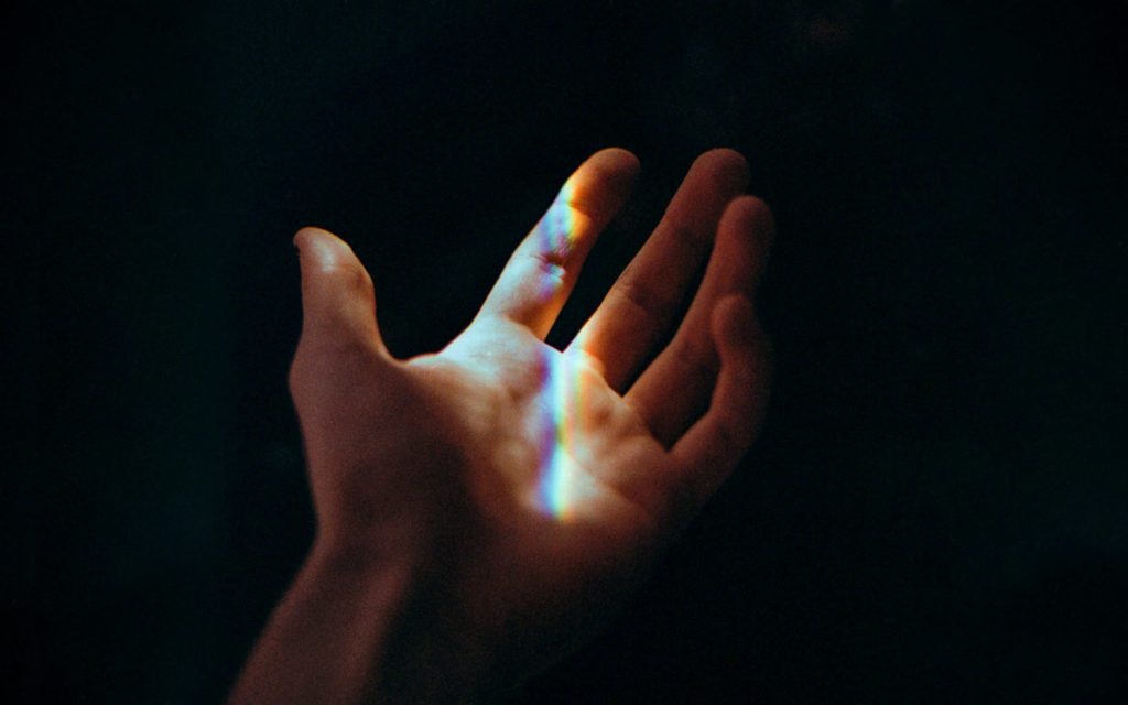 persons left hand with blue light